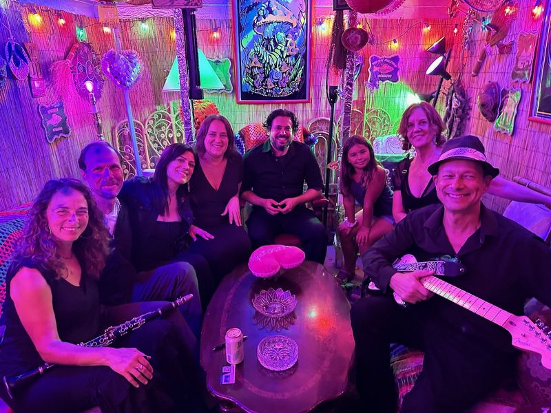 Band members gathered in a colorful lounge setting